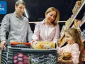 Rodzina robi zakupy w tanich sklepach spożywczych w Holandii. W wózku makaron i inne produkty.